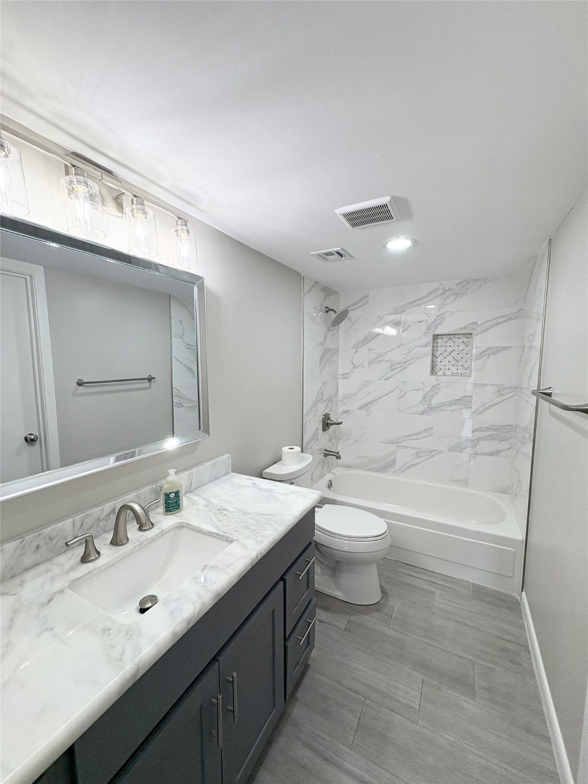 2800 Jeanetta Street, Unit 408 Houston, TX 77063 - Photo 12 of 14 a bathroom with a double vanity sink toilet and shower