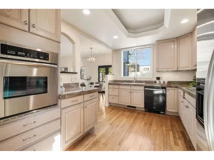 a kitchen with stainless steel appliances granite countertop a stove a sink and a microwave