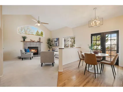 a view of a dining room with furniture a chandelier and wooden floor