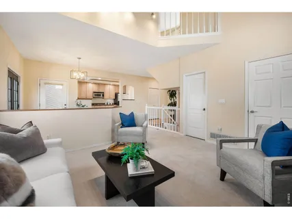 a living room with furniture and a kitchen