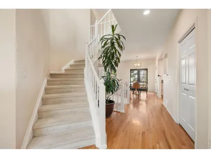 a view of entryway and hall with wooden floor