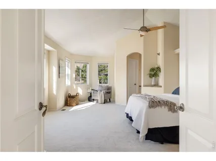 a bedroom with a bed couch and window