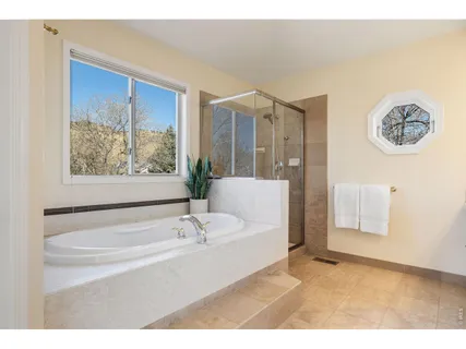 a bathroom with a bathtub and a shower