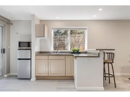 a kitchen with appliances cabinets and a sink