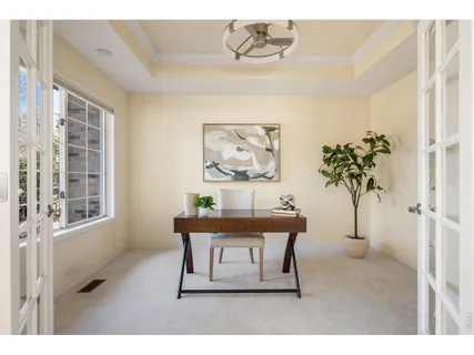 a view of a workspace with furniture and a potted plant