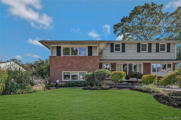 a front view of a house with a garden