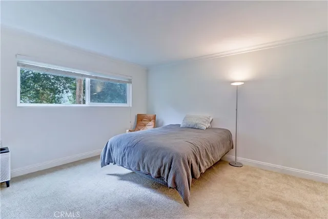 a bedroom with two beds lamp and a chandelier