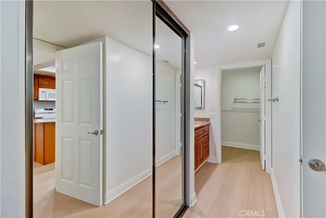 a view of a walk in closet and bathroom