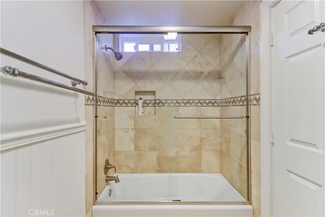 a bathroom with a glass shower door