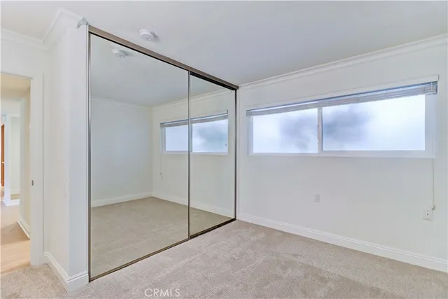 an empty room with windows and closet