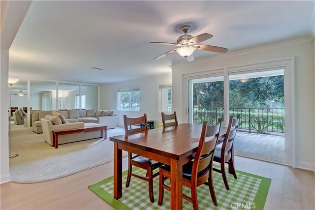 a dining room with furniture a rug and a chandelier