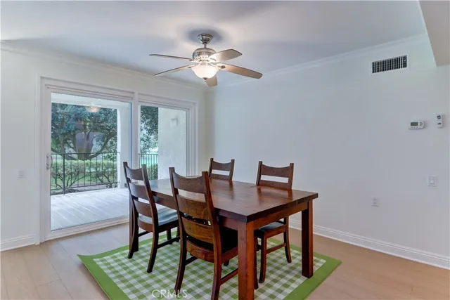 a view of a dining room with furniture wooden floor and a chandelier