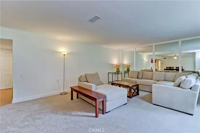a living room with furniture and a lamp