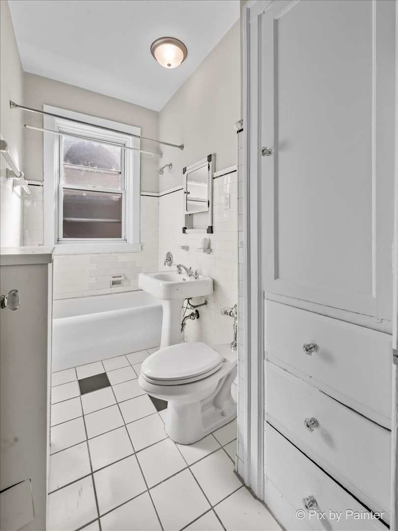 835 East 49th Street, Unit 3 Chicago, IL 60615 - Photo 12 of 16 a bathroom with a sink a toilet and shower