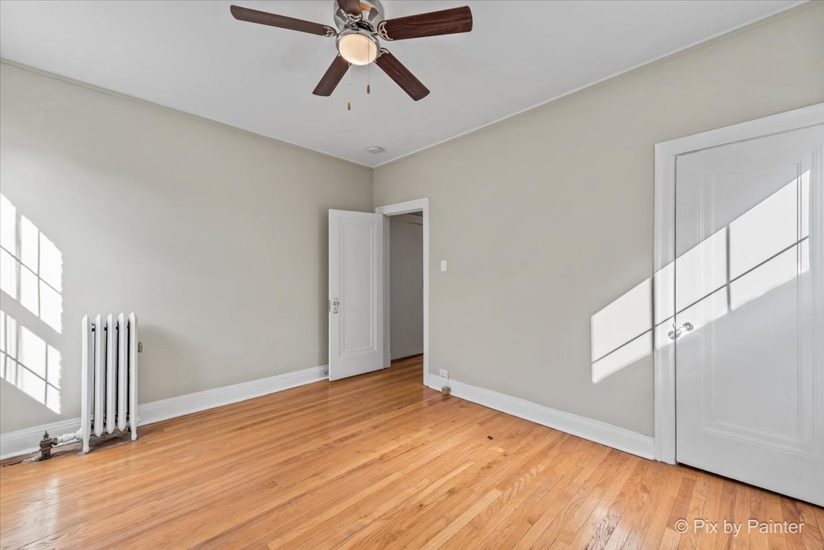 835 East 49th Street, Unit 3 Chicago, IL 60615 - Photo 14 of 16 a view of empty room with wooden floor and fan
