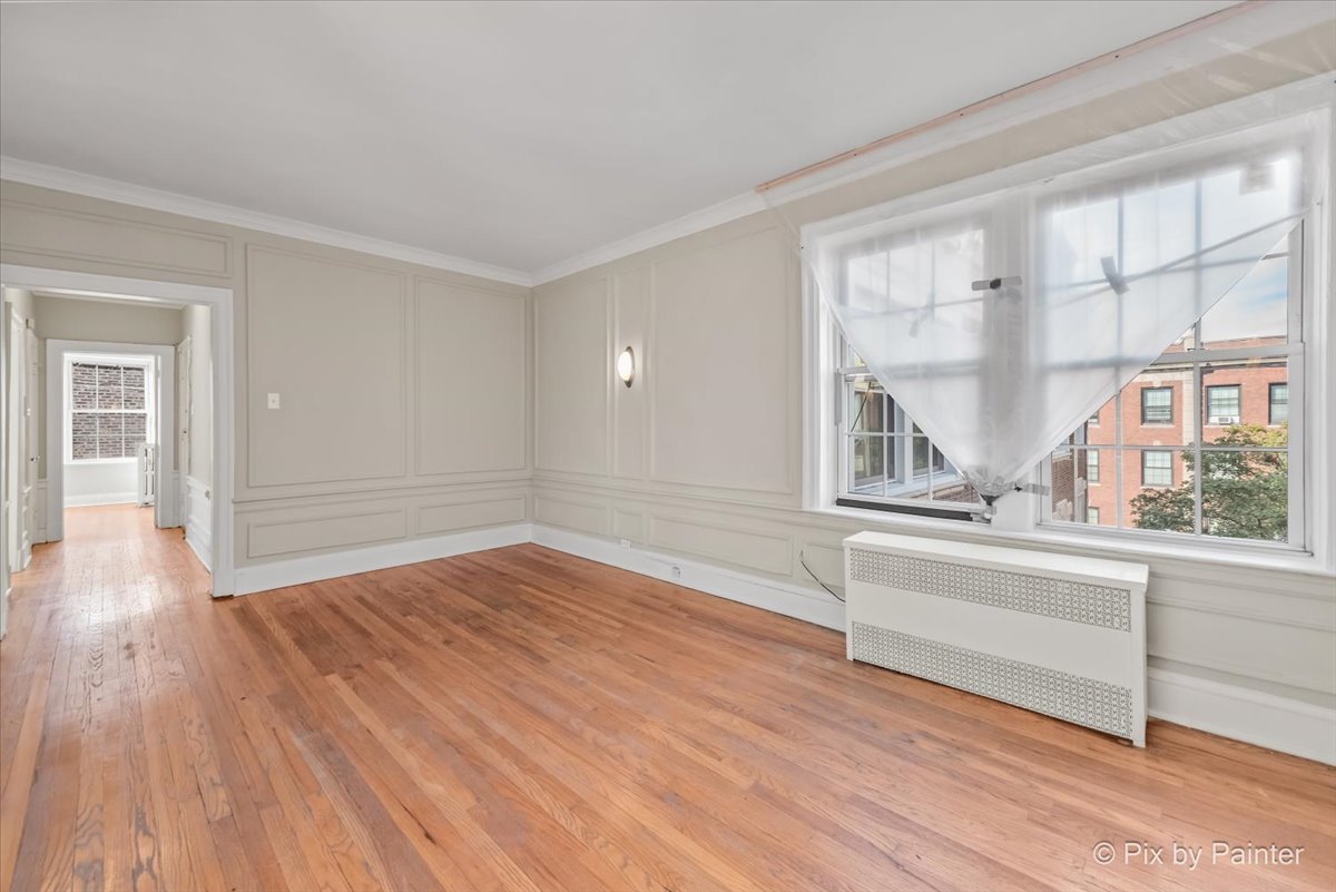 835 East 49th Street, Unit 3 Chicago, IL 60615 - Photo 4 of 16 wooden floor in an empty room with a window