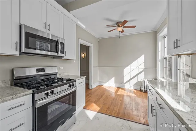 a kitchen with stainless steel appliances granite countertop a stove and a sink