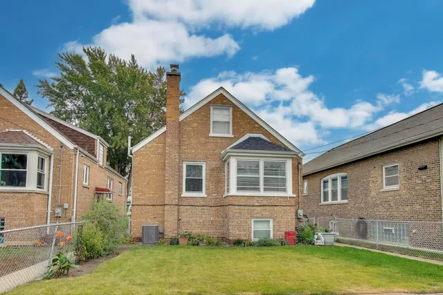 a front view of a house with yard patio and fire pit