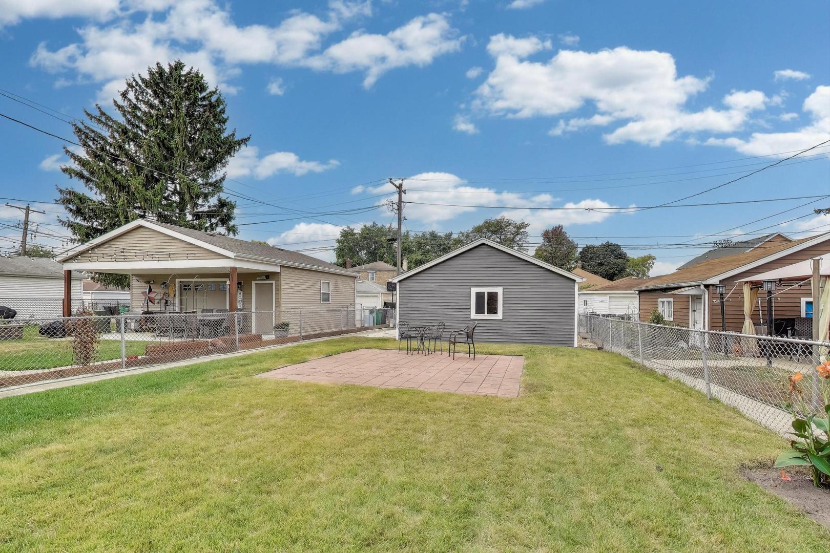 3816 Wisconsin Avenue Berwyn, IL 60402 - Photo 22 of 32 a front view of a house with yard patio and fire pit