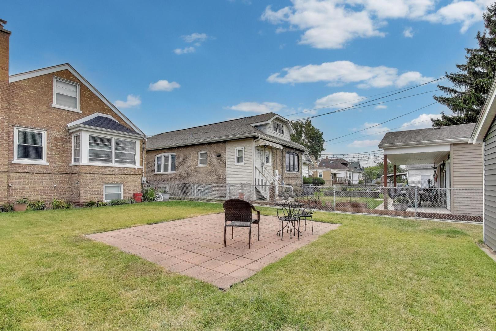 3816 Wisconsin Avenue Berwyn, IL 60402 - Photo 24 of 32 a front view of a house with a yard table and chairs