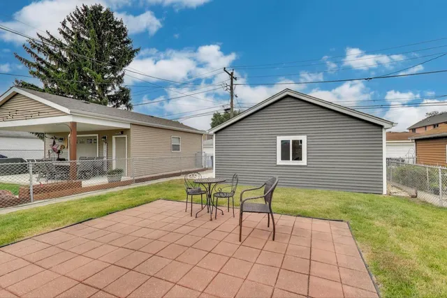 a view of a patio with table and chairs and wooden floor