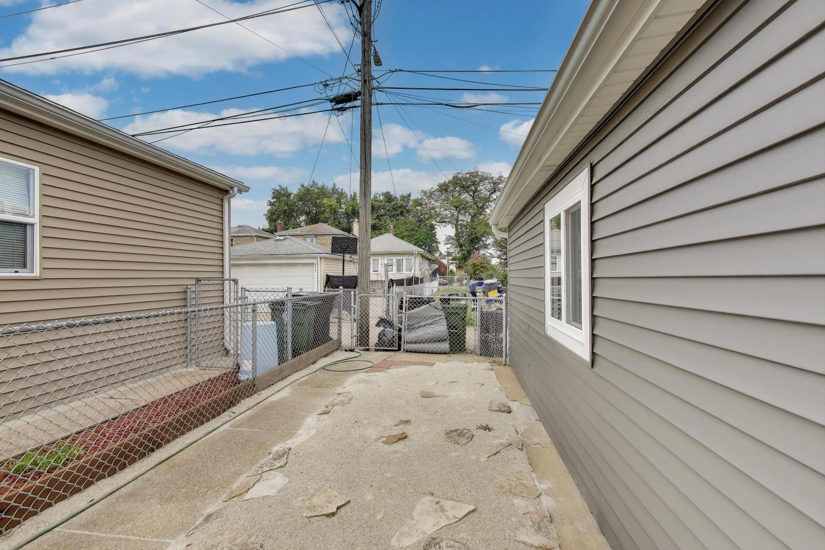 3816 Wisconsin Avenue Berwyn, IL 60402 - Photo 26 of 32 a view of a patio with table and chairs and wooden floor