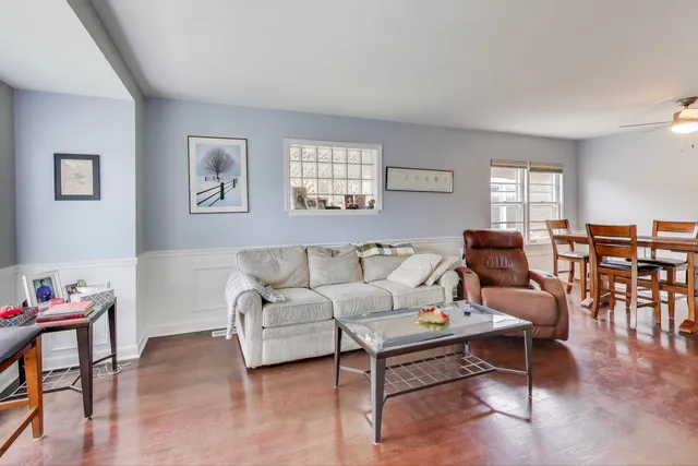 a living room with furniture and wooden floor