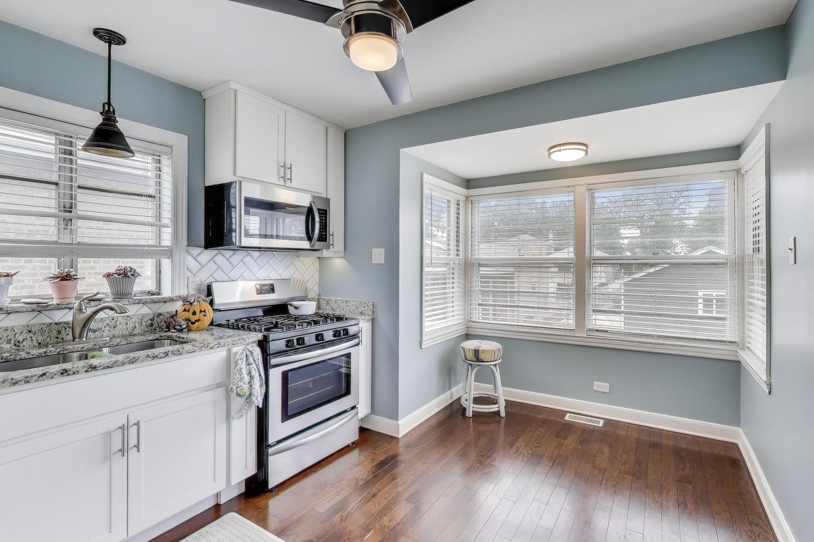 3816 Wisconsin Avenue Berwyn, IL 60402 - Photo 9 of 32 a kitchen with a stove a sink and a microwave
