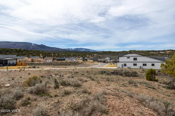 a view of a big yard with an buildings in the background