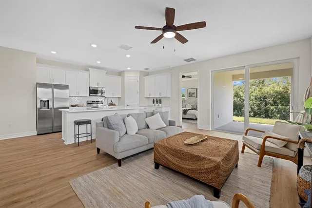 a living room with furniture and a large window