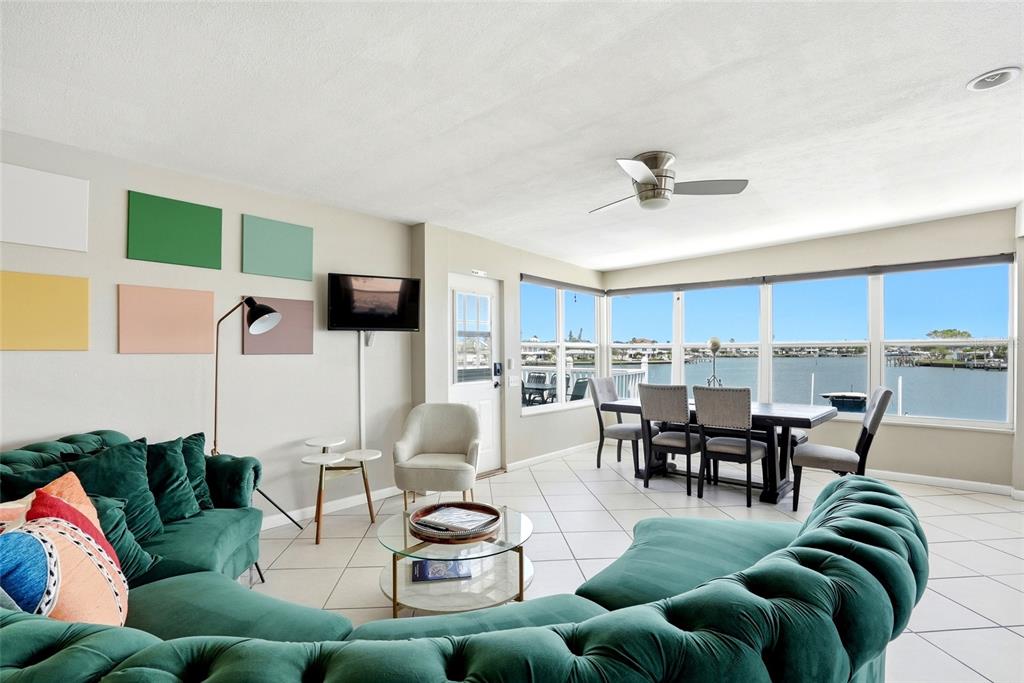 2311 Bay Boulevard Indian Rocks Beach, FL 33785 - Photo 6 of 80 a living room with furniture a rug and a flat screen tv