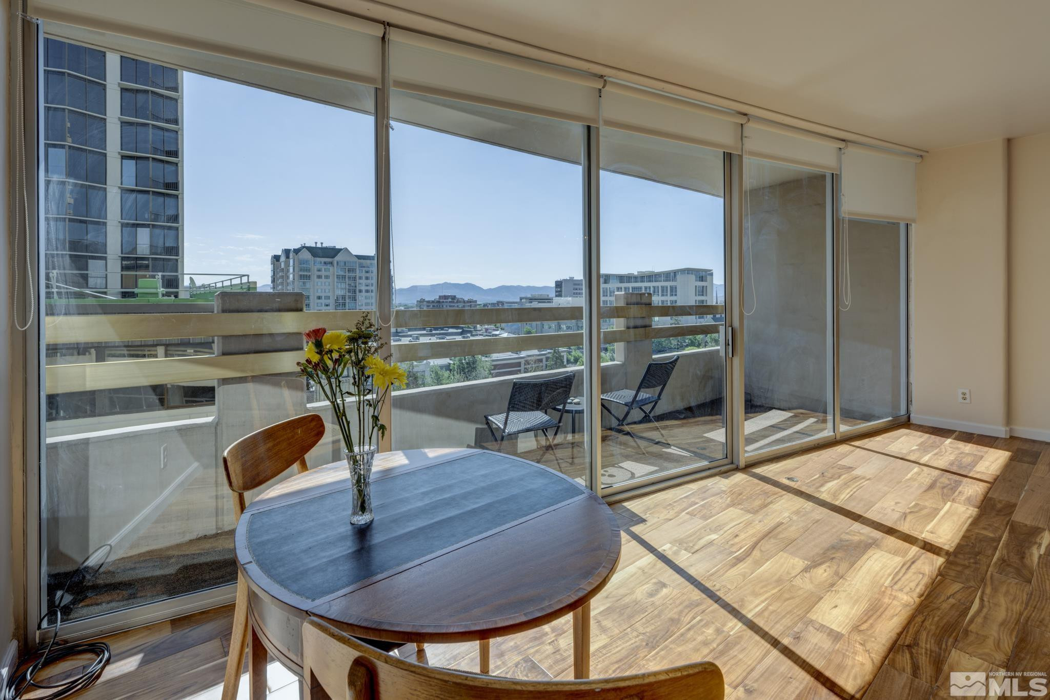 100 North Arlington Avenue, Unit 6B Reno, NV 89501 - Photo 1 of 23 a view of a dining room with furniture window and outside view