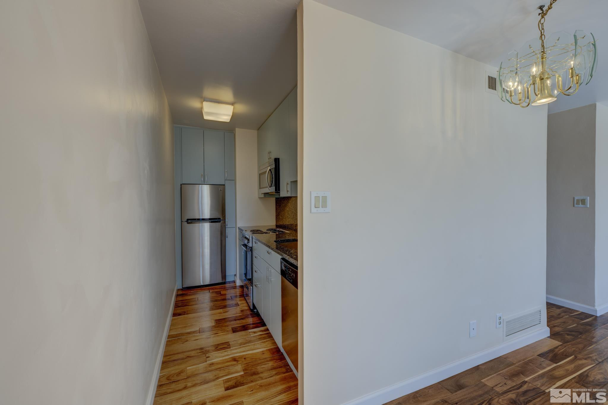 100 North Arlington Avenue, Unit 6B Reno, NV 89501 - Photo 6 of 23 a view of a hallway with wooden floor and staircase
