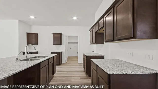a kitchen with granite countertop stainless steel appliances and sink