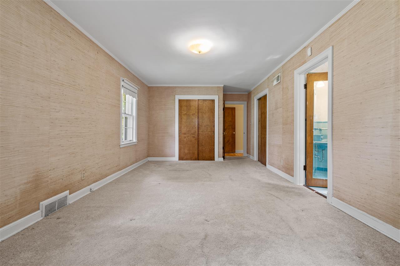 4810 Shady Grove Road Memphis, TN 38117 - Photo 12 of 20 Spacious 19x12 Primary Bedroom features Hardwood under Carpet, 4 Double Closets, and Shared Bath