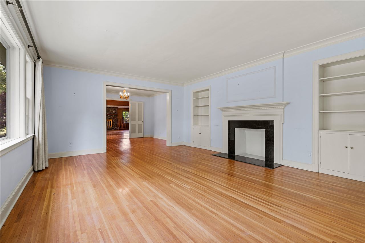 4810 Shady Grove Road Memphis, TN 38117 - Photo 4 of 20 19x15 Living Room features Fireplace, Hardwood, Smooth Ceiling, Crown Molding and Custom Built-In Bookcases