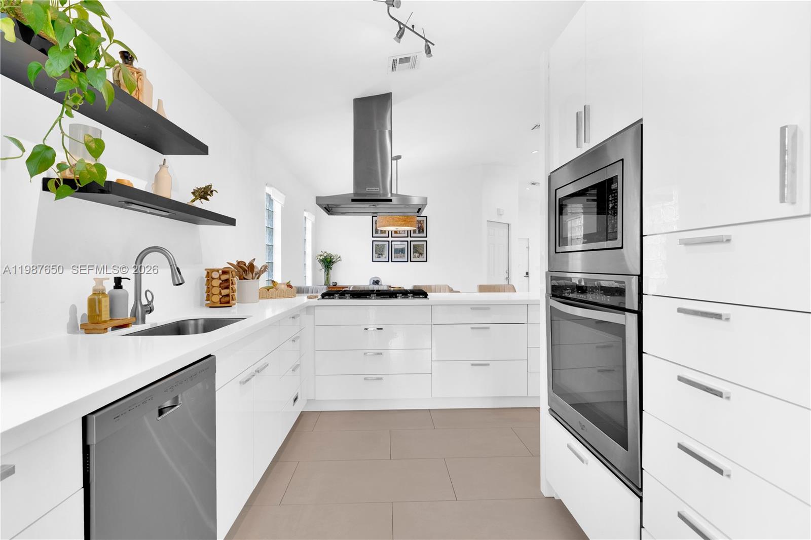 a kitchen with granite countertop white cabinets and white appliances