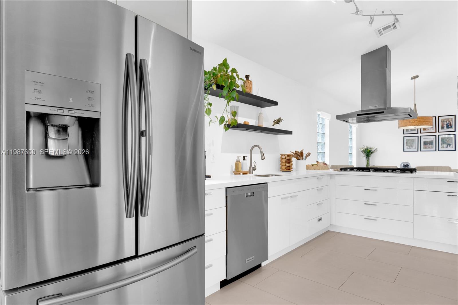 8858 Southwest 214th Street Cutler Bay, FL 33189 - Photo 14 of 41 a kitchen with white cabinets and refrigerator