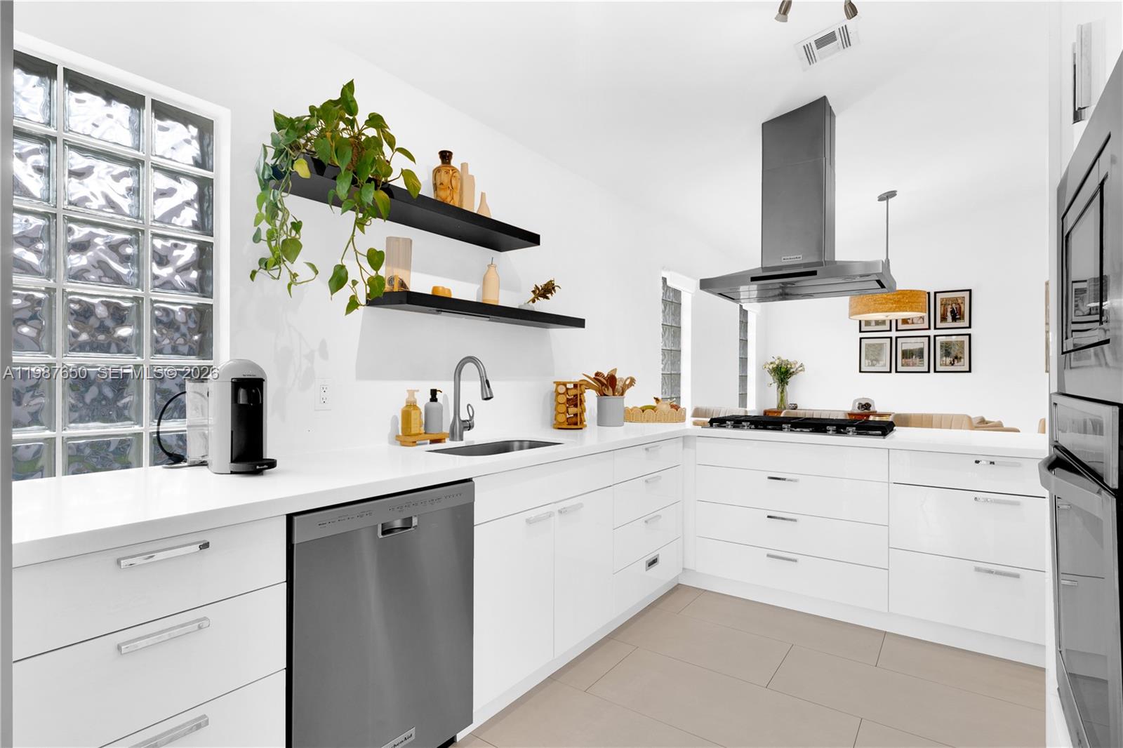 8858 Southwest 214th Street Cutler Bay, FL 33189 - Photo 15 of 41 a kitchen with white cabinets and sink