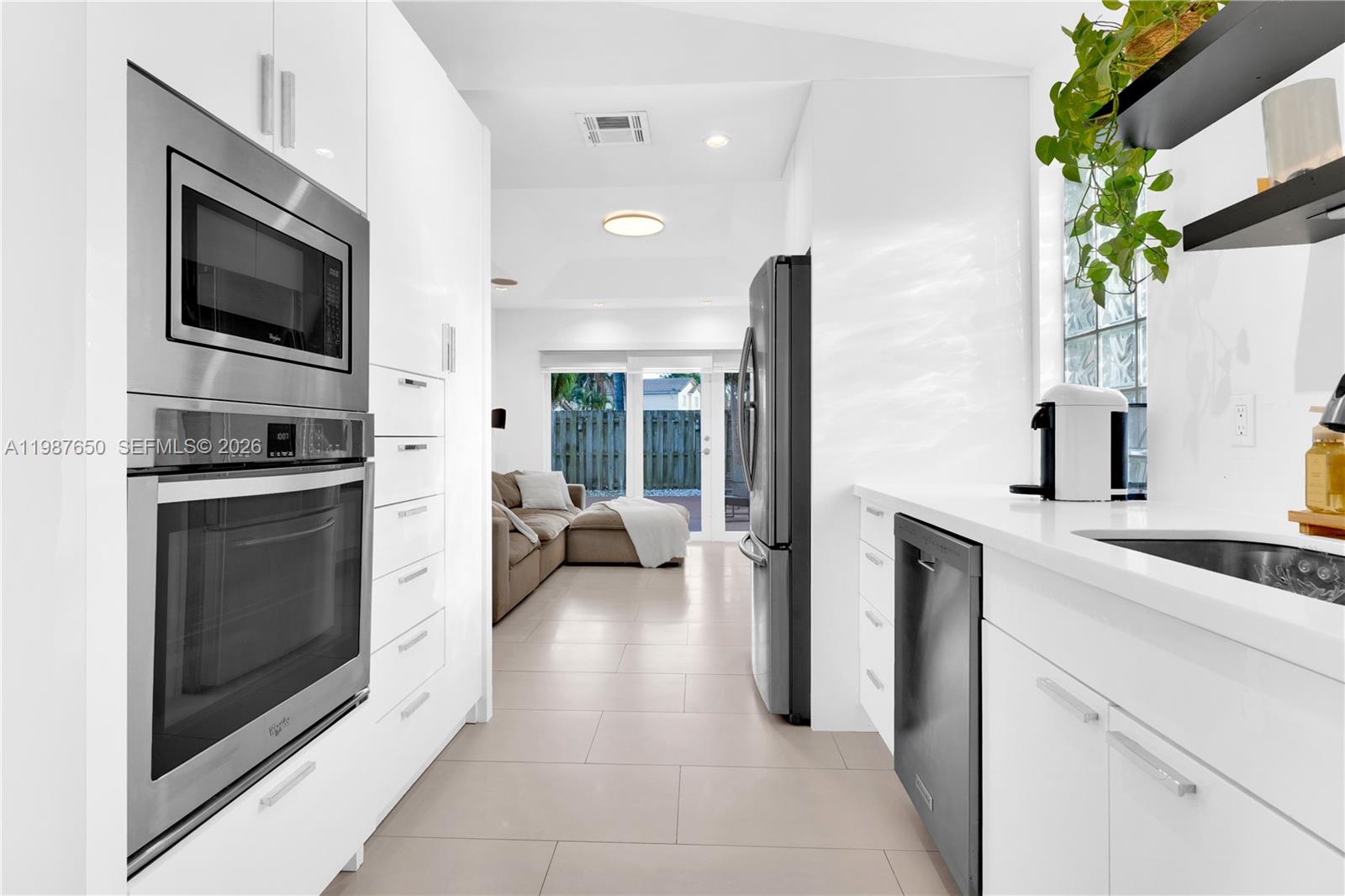 8858 Southwest 214th Street Cutler Bay, FL 33189 - Photo 16 of 41 a kitchen with a sink and stainless steel appliances