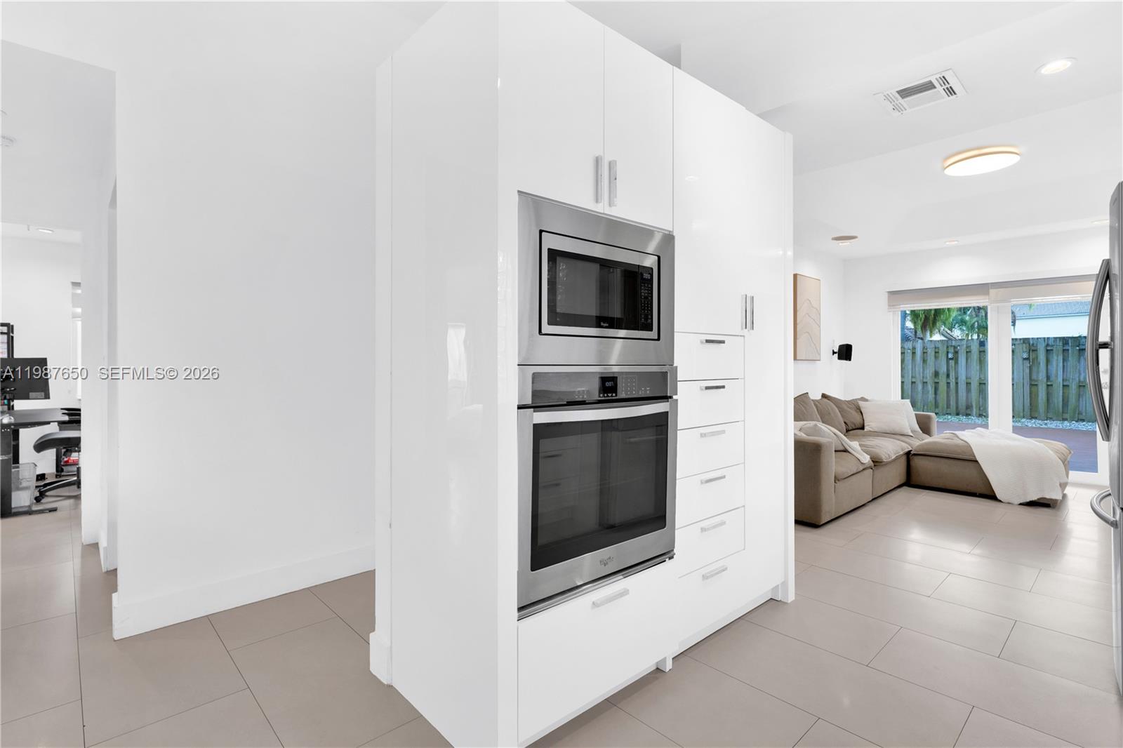 8858 Southwest 214th Street Cutler Bay, FL 33189 - Photo 17 of 41 a kitchen with stainless steel appliances a stove a microwave and a refrigerator
