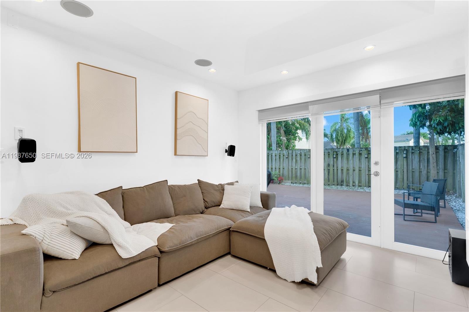 8858 Southwest 214th Street Cutler Bay, FL 33189 - Photo 20 of 41 a living room with furniture and a large window