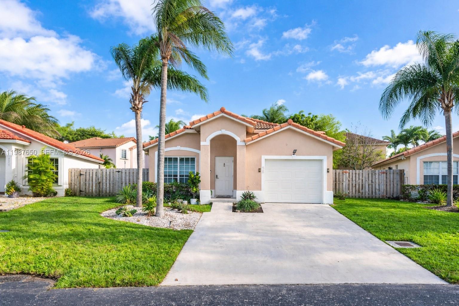8858 Southwest 214th Street Cutler Bay, FL 33189 - Photo 2 of 41 a front view of house with yard and green space