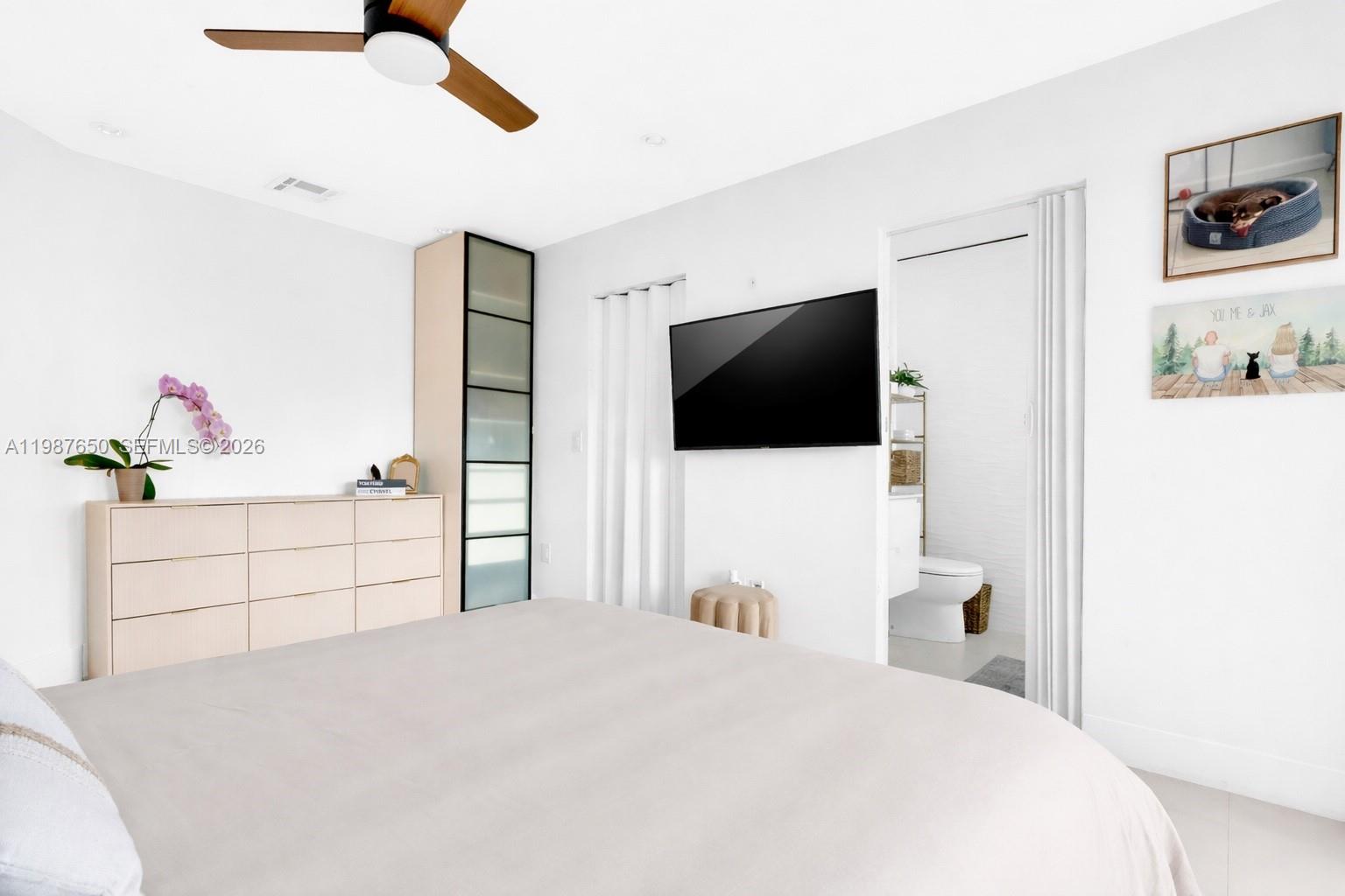 8858 Southwest 214th Street Cutler Bay, FL 33189 - Photo 24 of 41 a bedroom with a bed and a flat screen tv