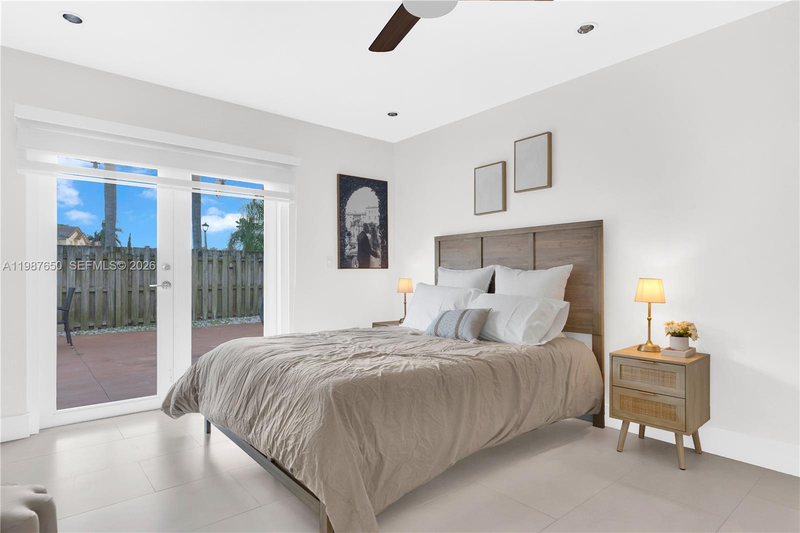 8858 Southwest 214th Street Cutler Bay, FL 33189 - Photo 25 of 41 a bedroom with a bed a lamp and window