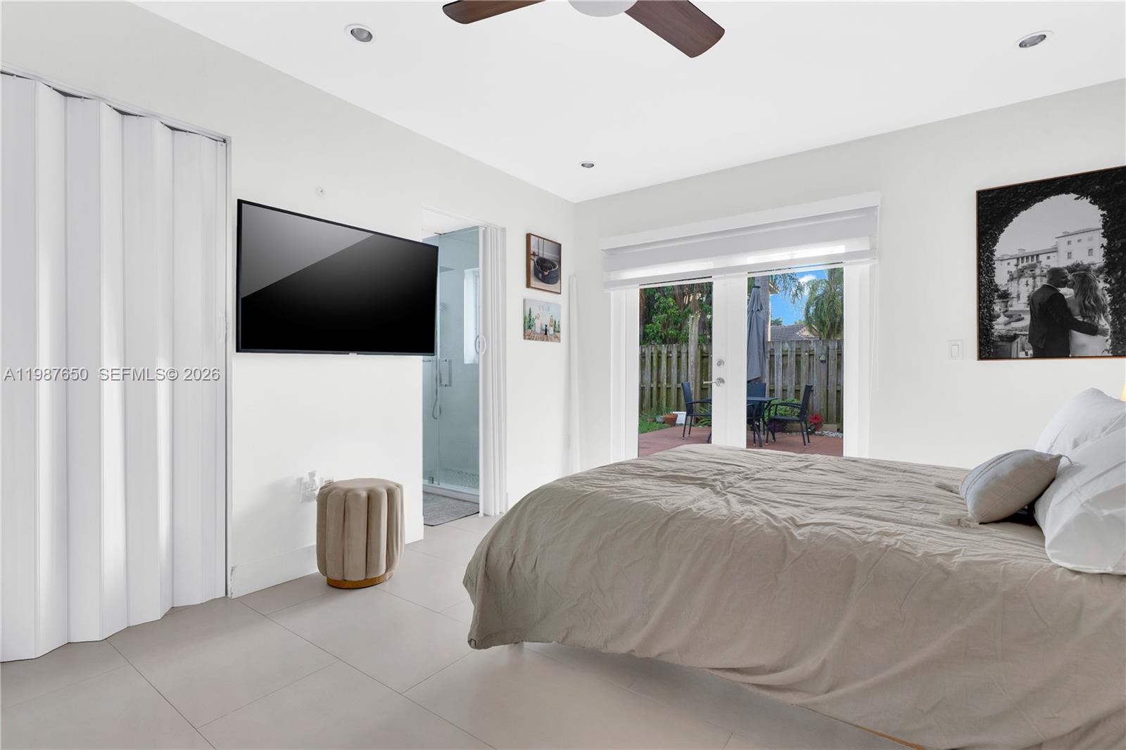8858 Southwest 214th Street Cutler Bay, FL 33189 - Photo 26 of 41 a bedroom with bed and flat screen tv
