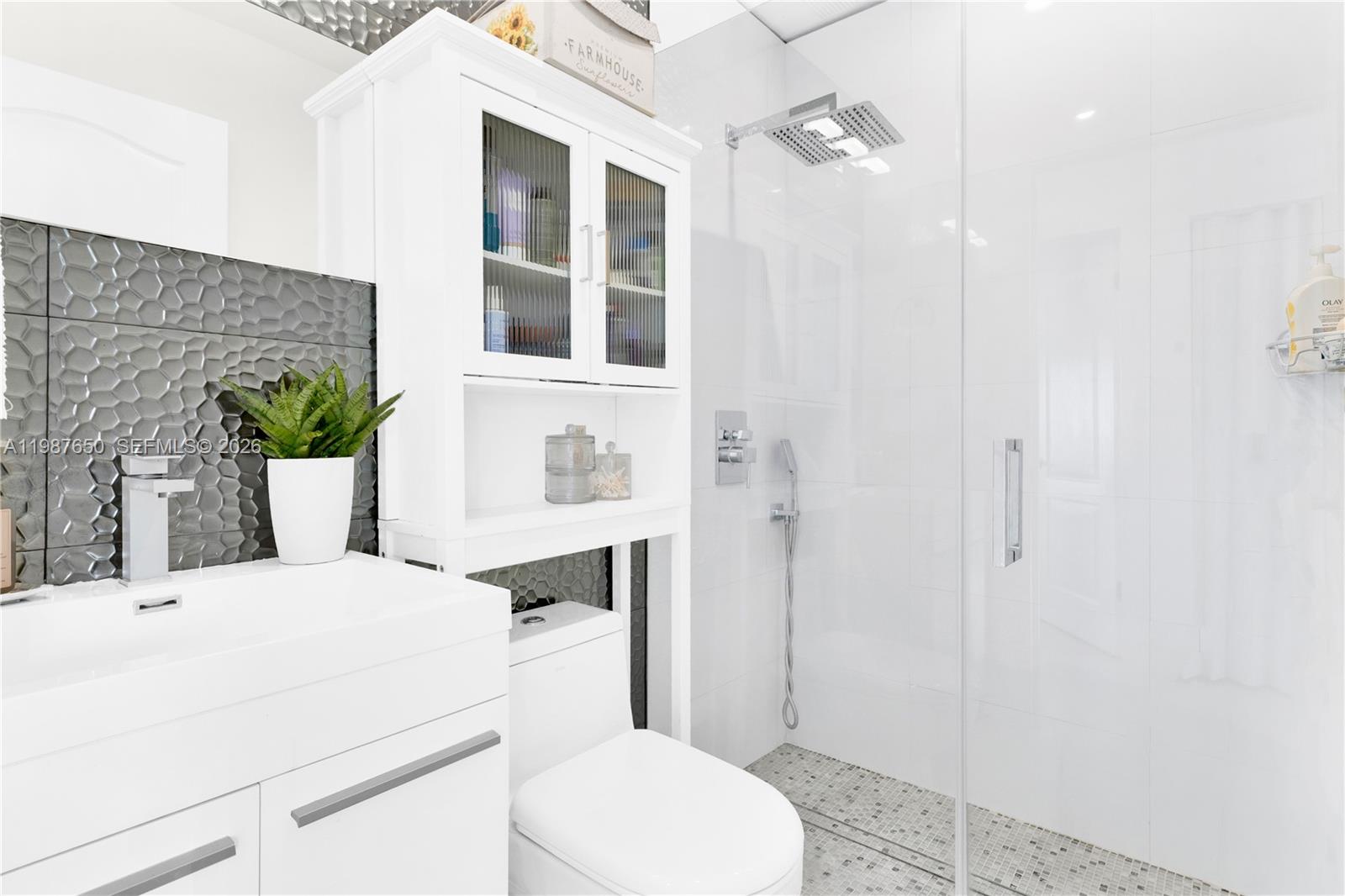 8858 Southwest 214th Street Cutler Bay, FL 33189 - Photo 32 of 41 a bathroom with a sink toilet and shower
