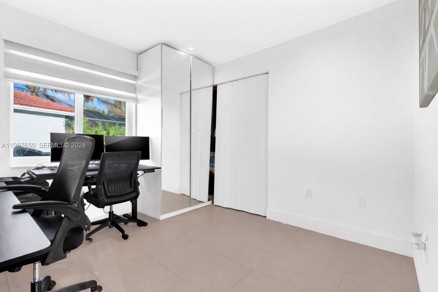 8858 Southwest 214th Street Cutler Bay, FL 33189 - Photo 33 of 41 a view of a workspace with furniture and a window