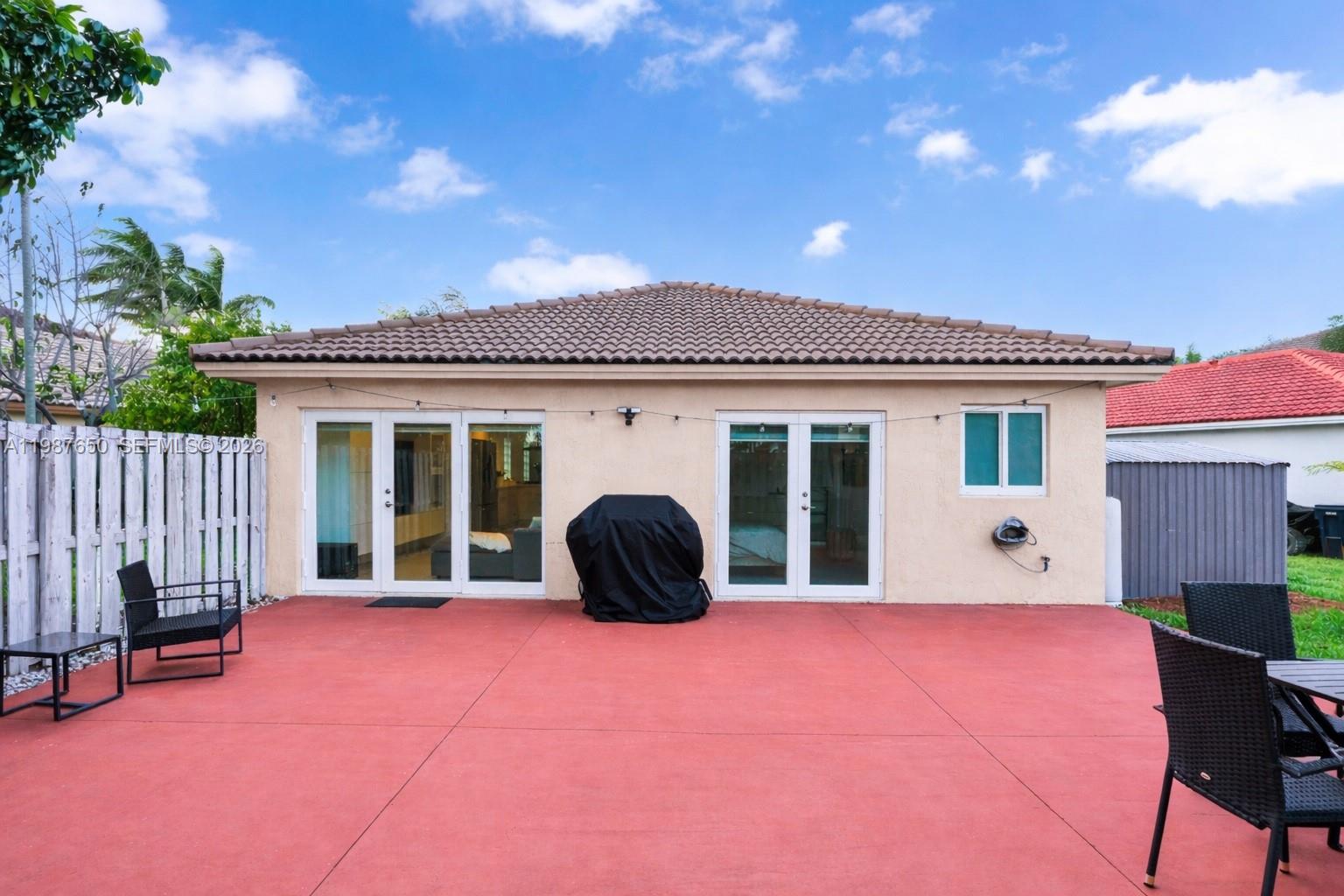 8858 Southwest 214th Street Cutler Bay, FL 33189 - Photo 35 of 41 a view of a house with porch and chairs