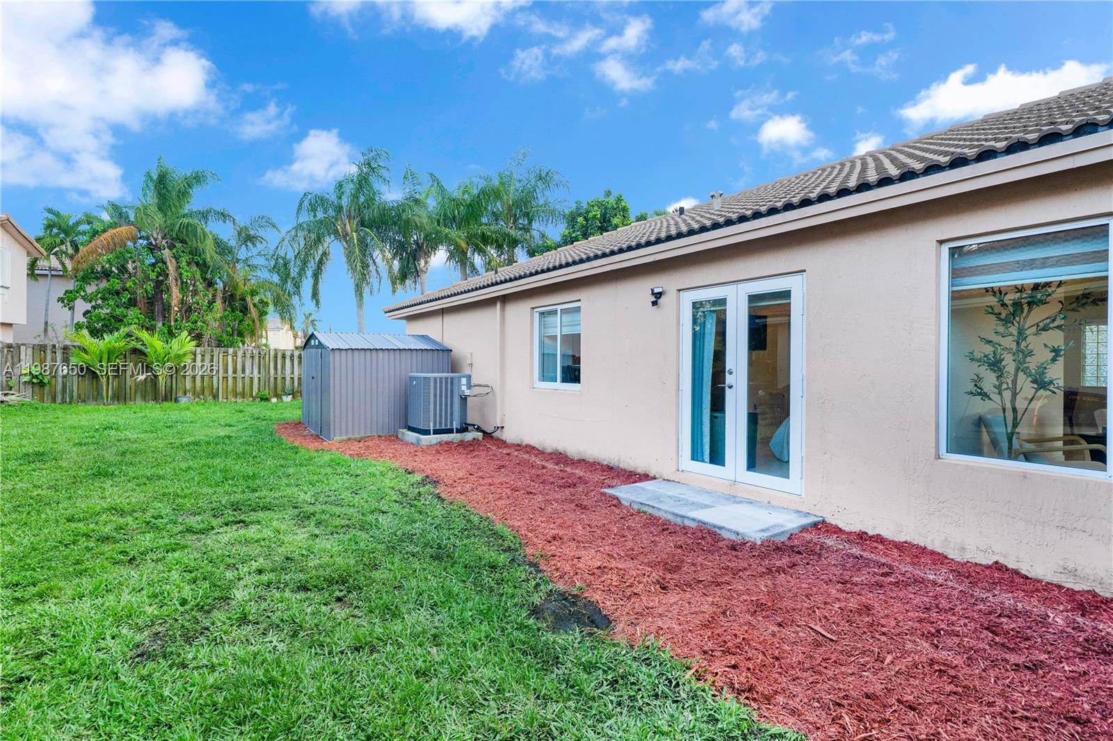 8858 Southwest 214th Street Cutler Bay, FL 33189 - Photo 39 of 41 a view of a house with a backyard